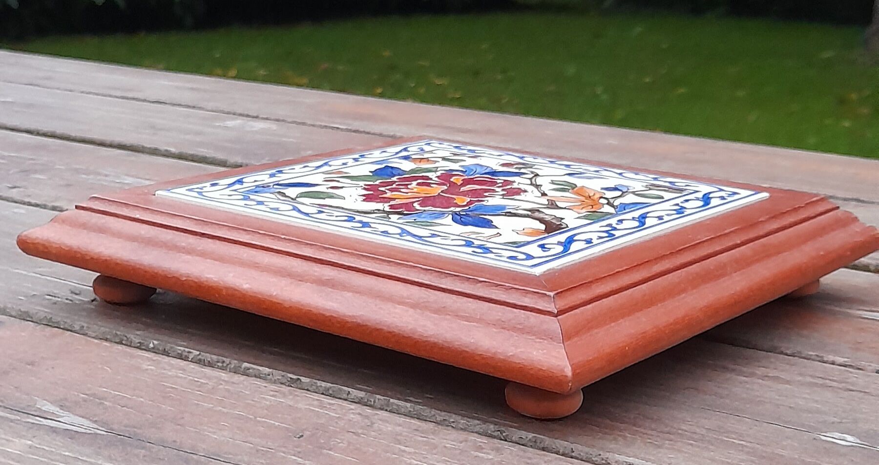 Underside of flat wood and faience floral pattern - retro