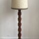 Brutalist floor lamp in turned wood, in the style of Charles Dudouyt.