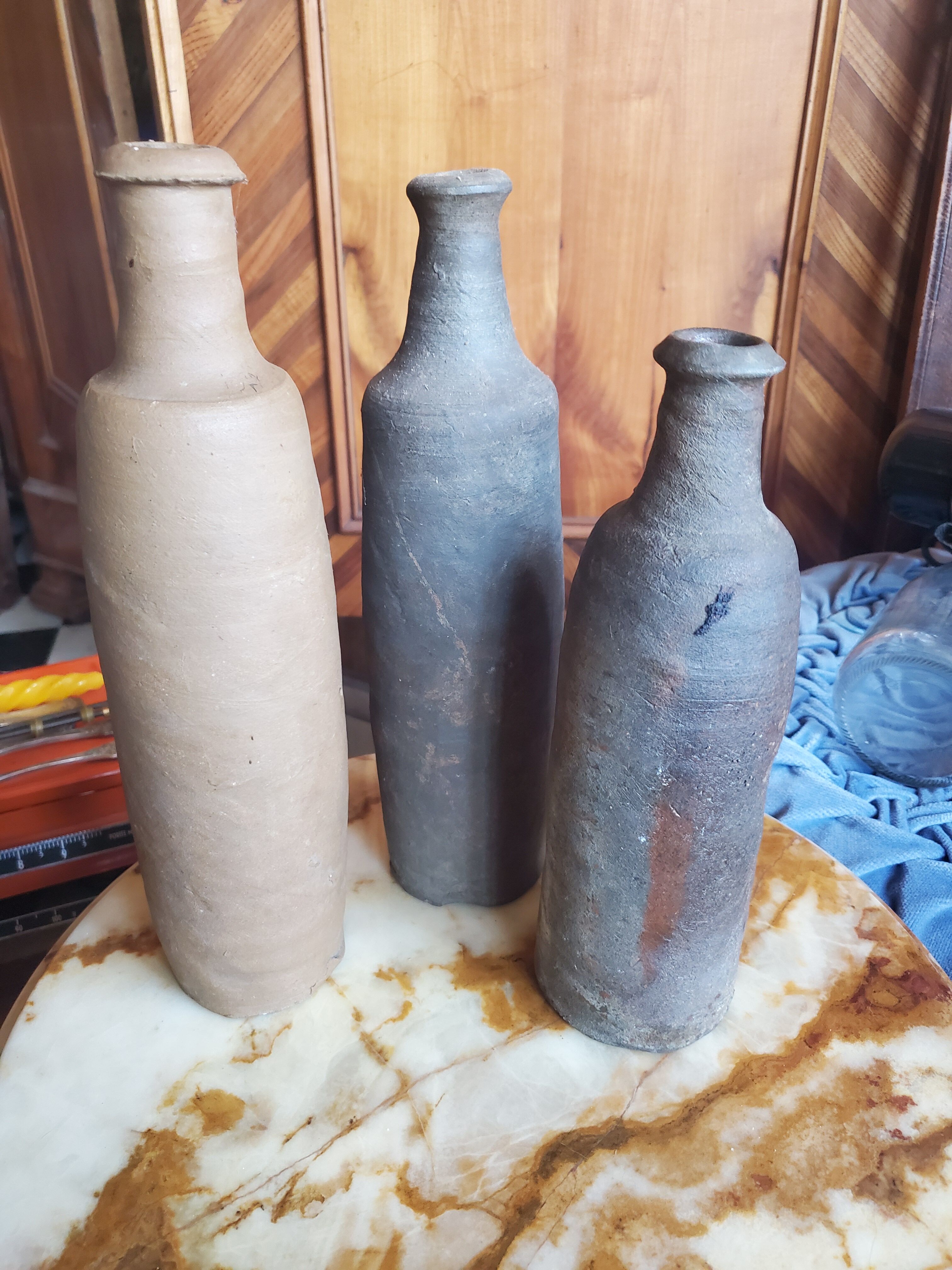 3 terracotta bottles