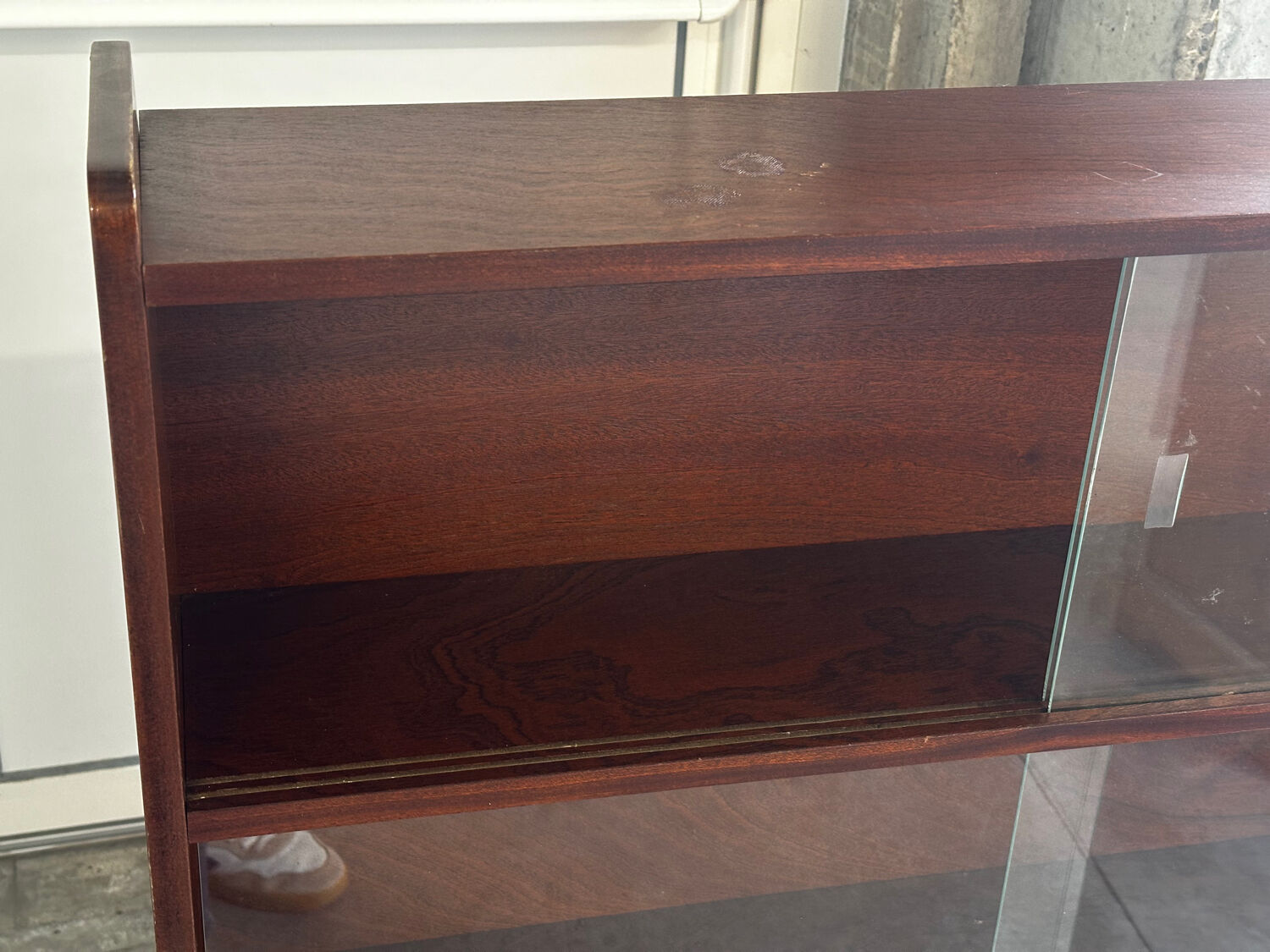Vintage 1960s wooden library with sliding doors.
