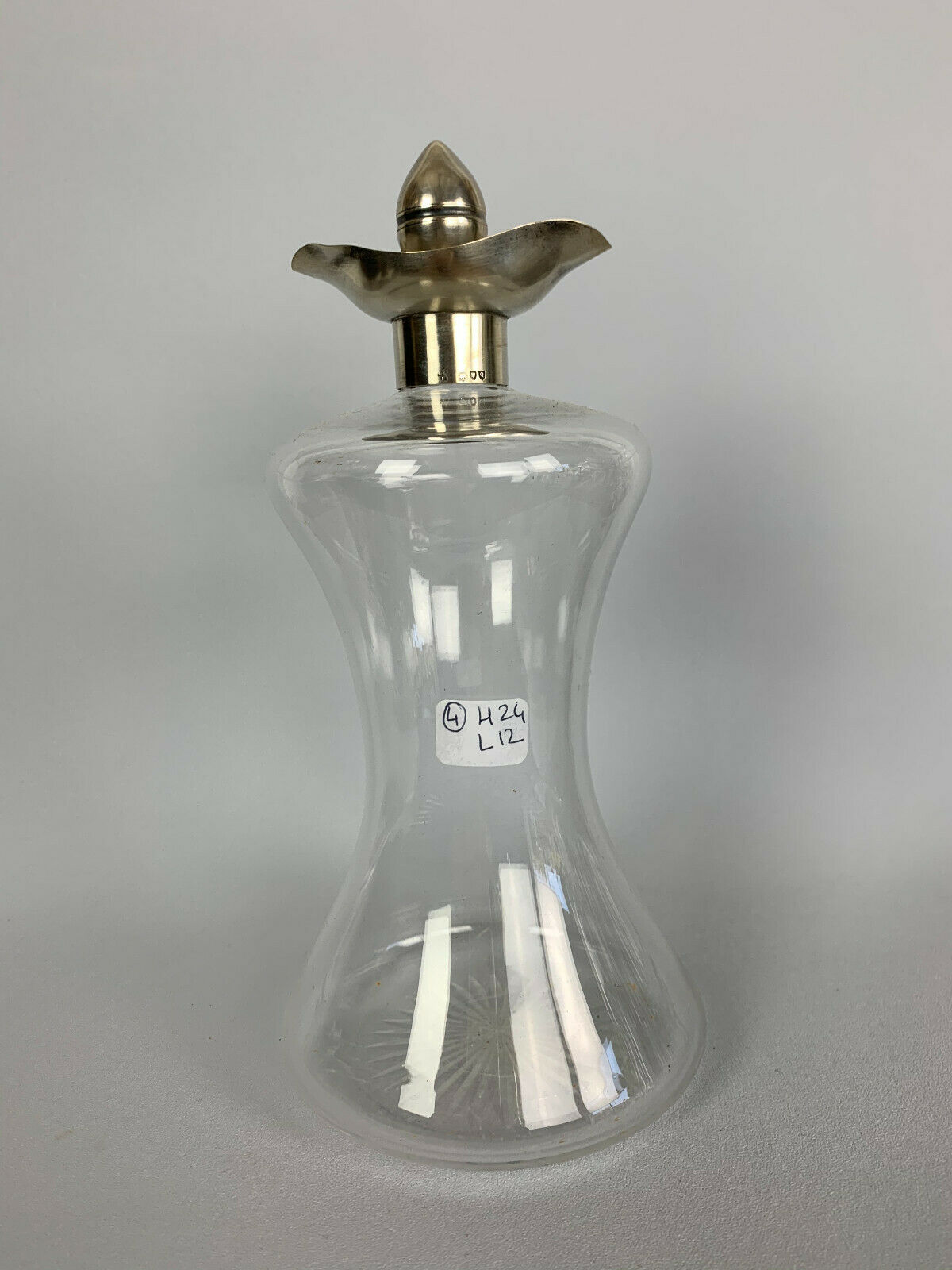 Blown glass carafe with silver frame and cap