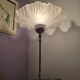 Table lamp with a silver base and a frilled shade.