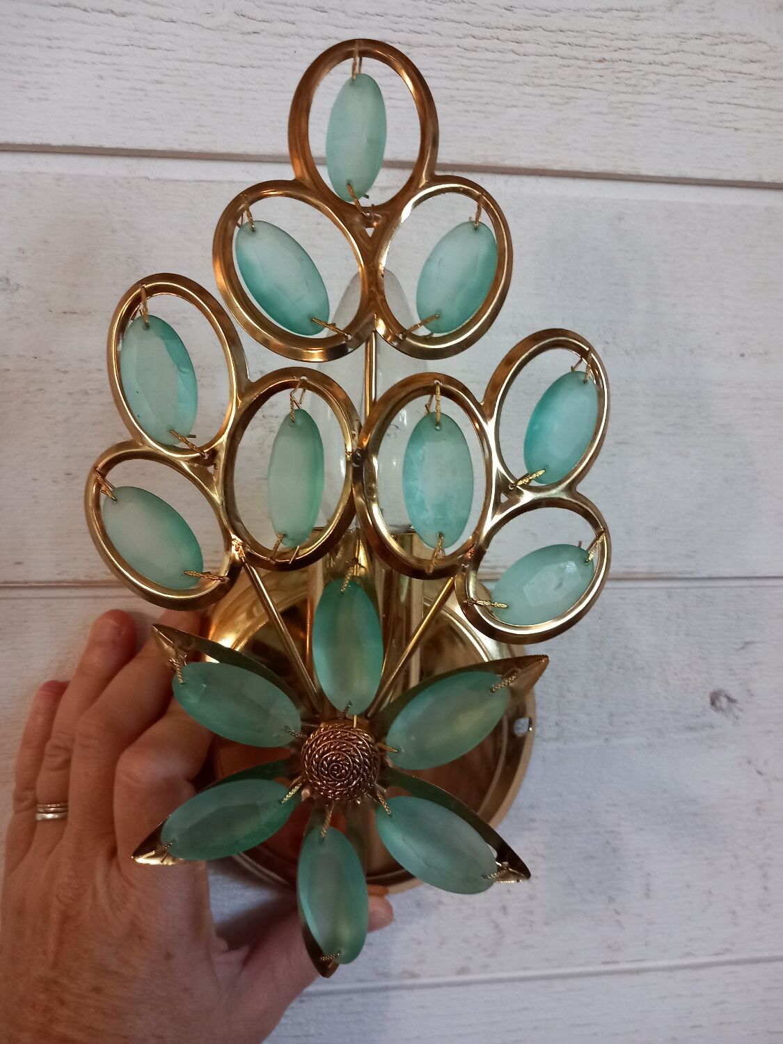 Gold metal wall light with light blue tassels