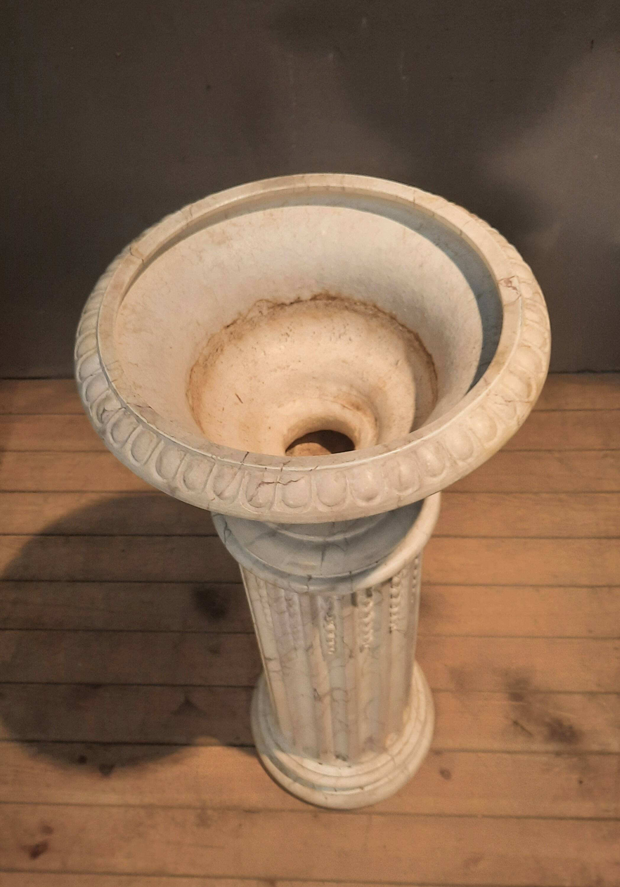 Column topped with a plaster basin.