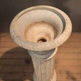 Column topped with a plaster basin.