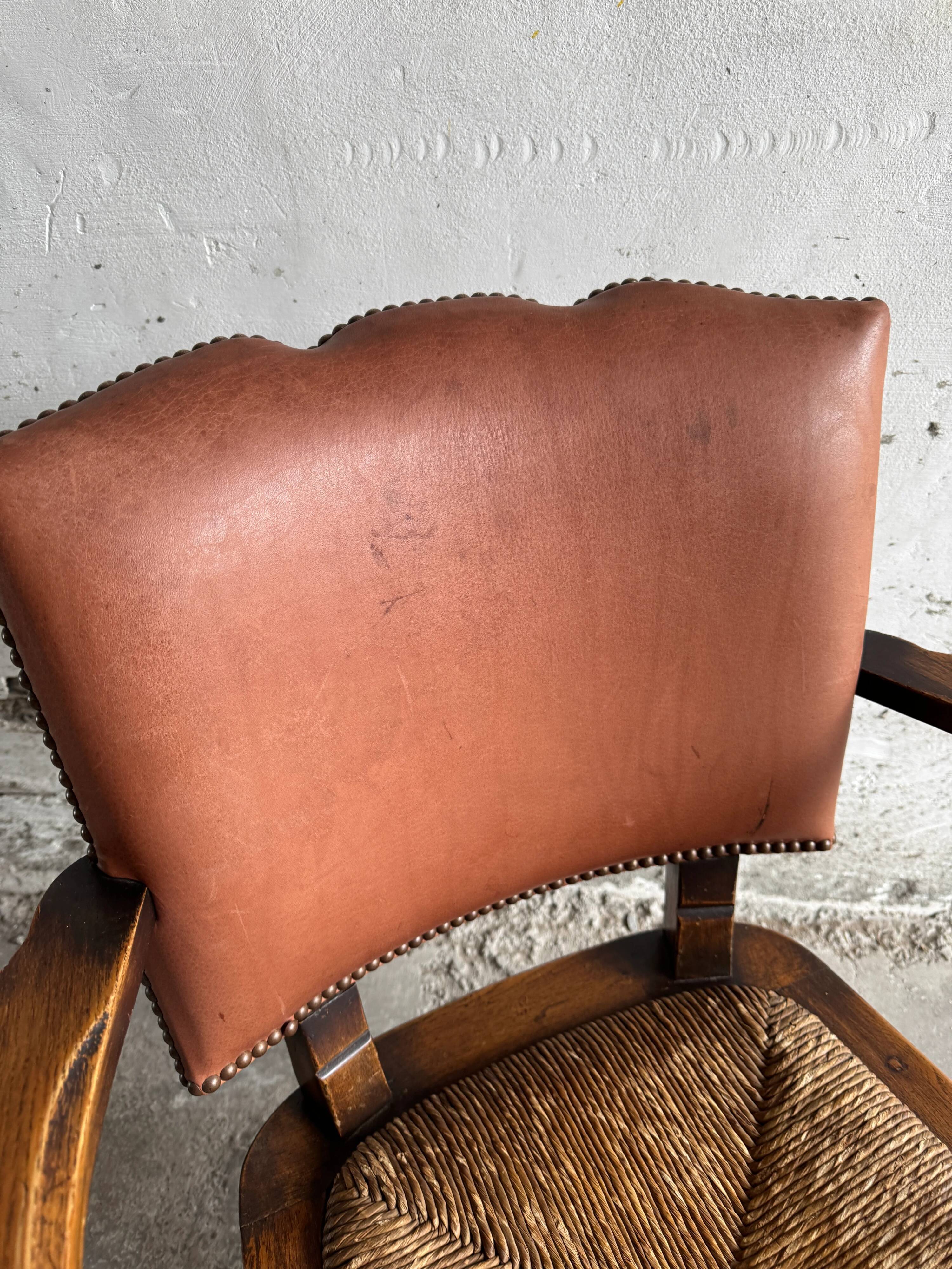 Brutalist dark brown solid wood armchair with natural rattan seat and cognac leather back