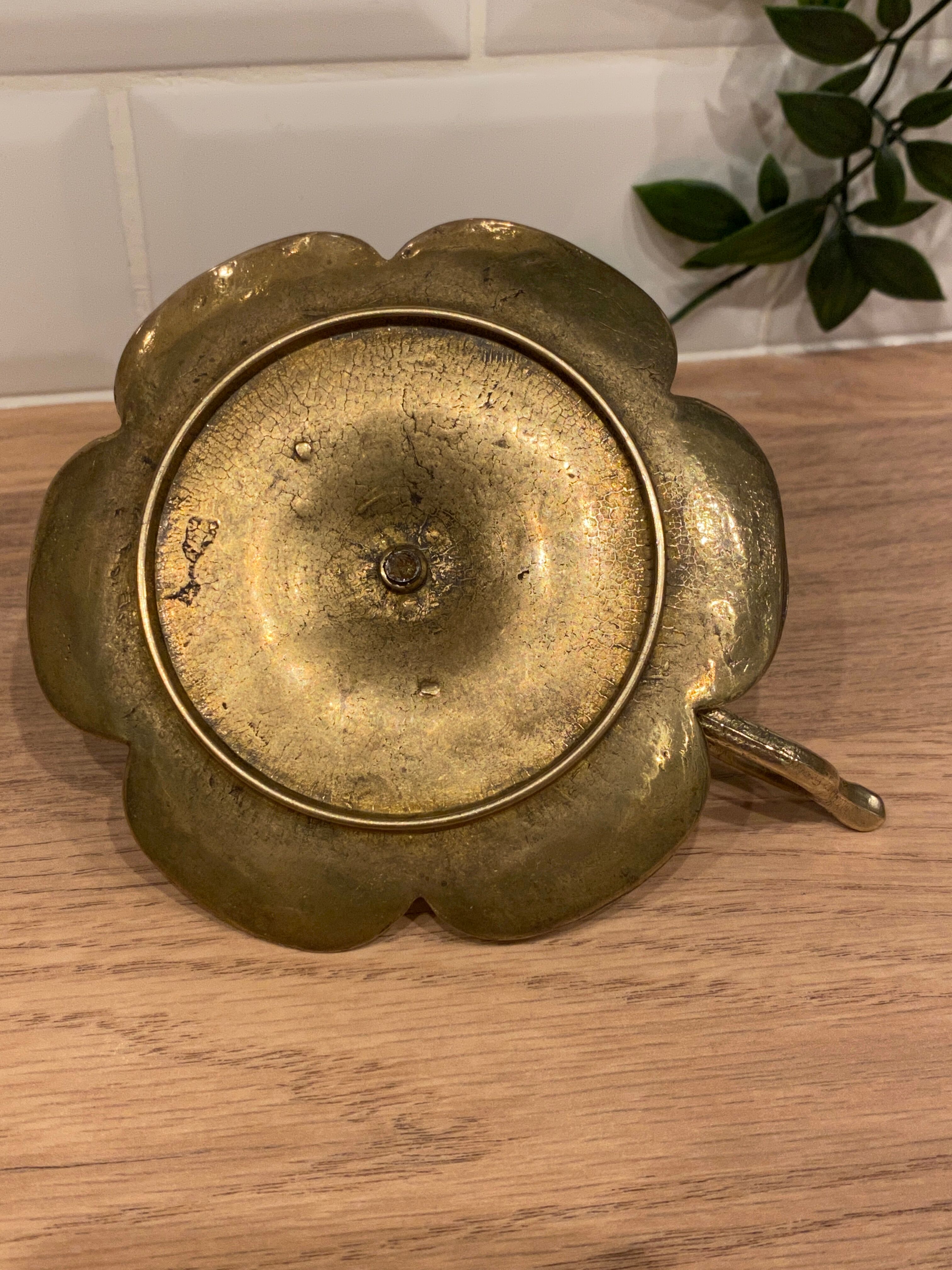 Brass candle holder on frame