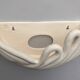 Draped ceramic wall light in a half-moon shape.