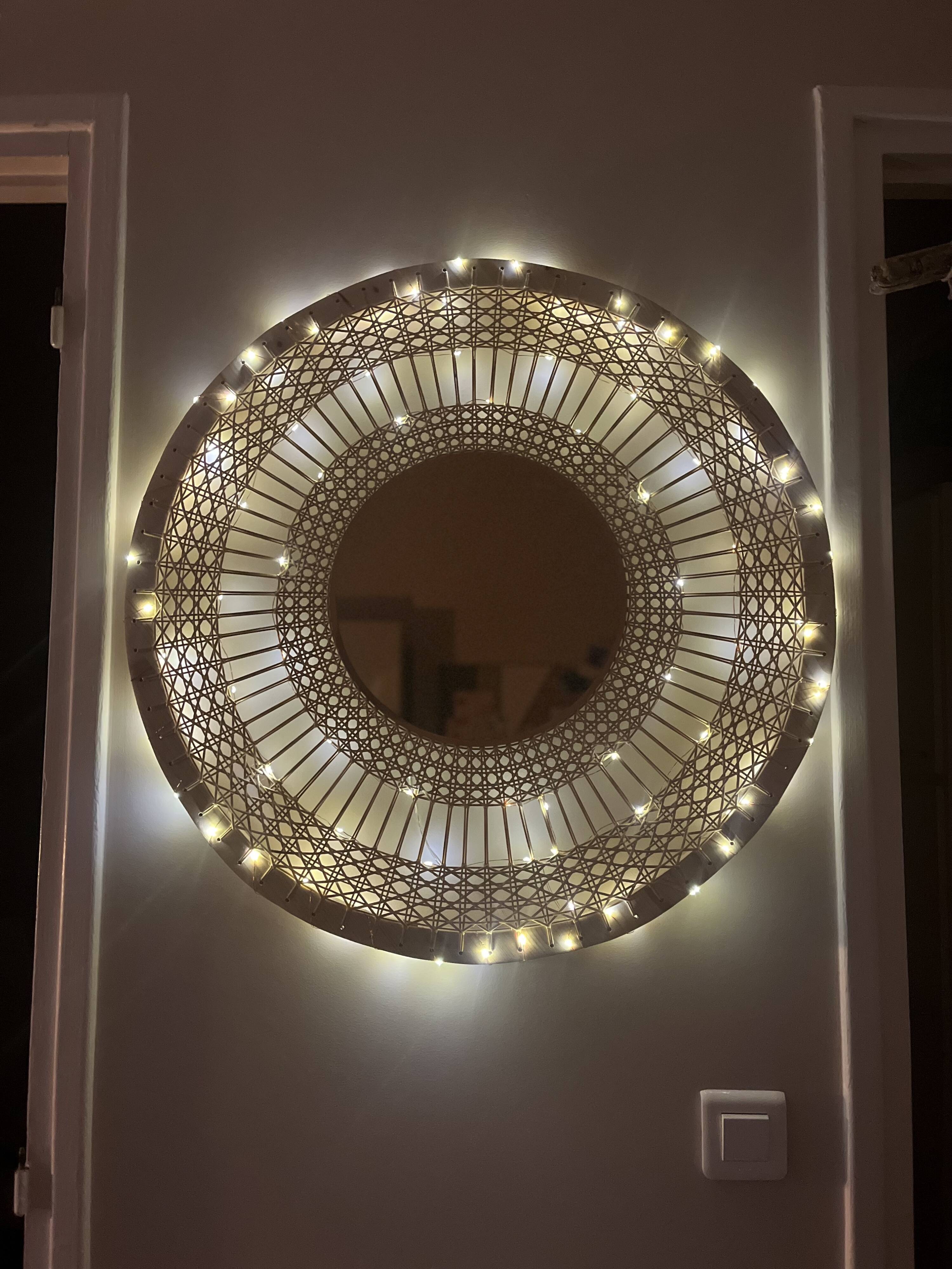 Decorative mirror in woven sun cane