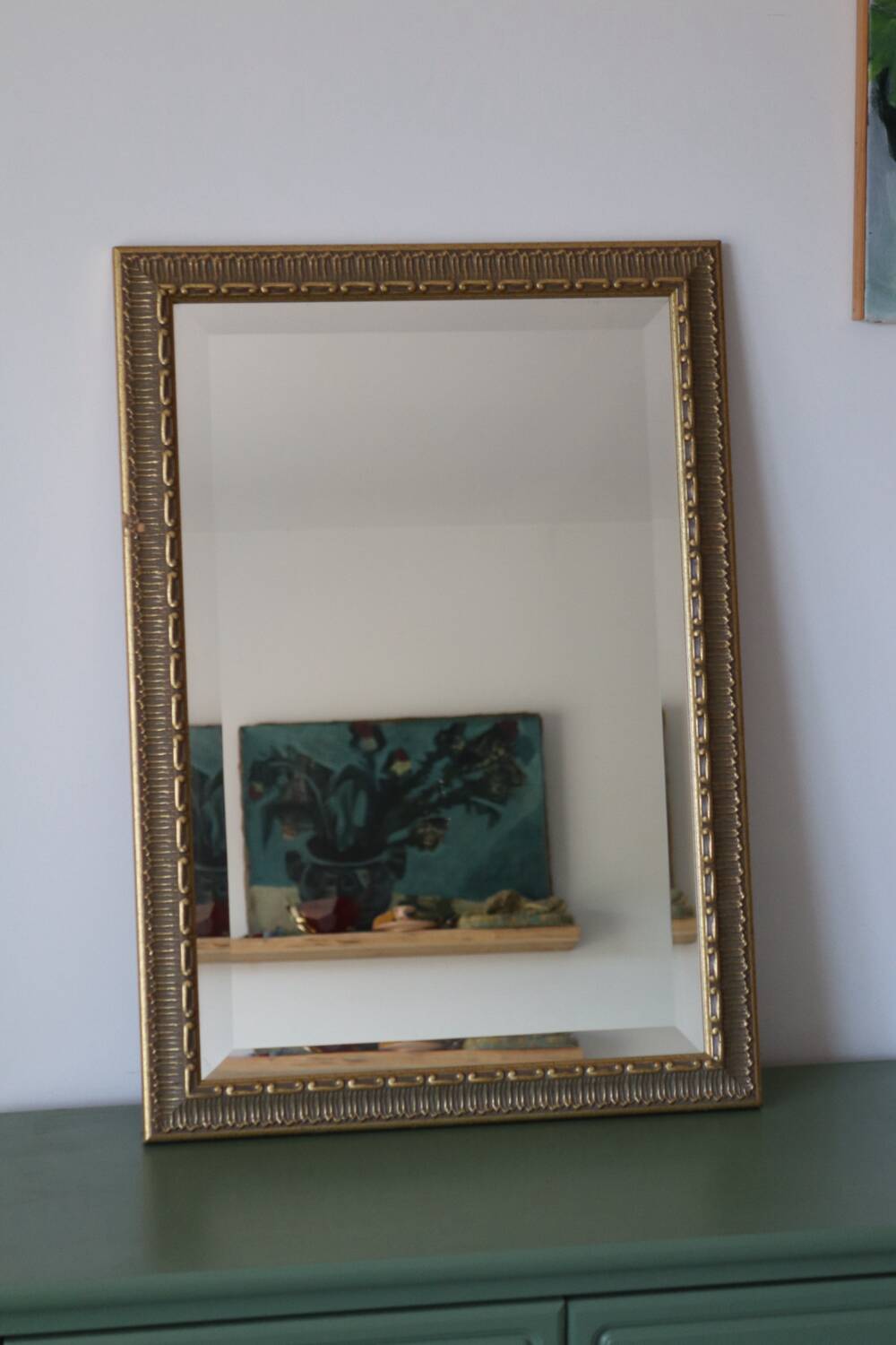 Rectangular gold mirror with moulded decoration.