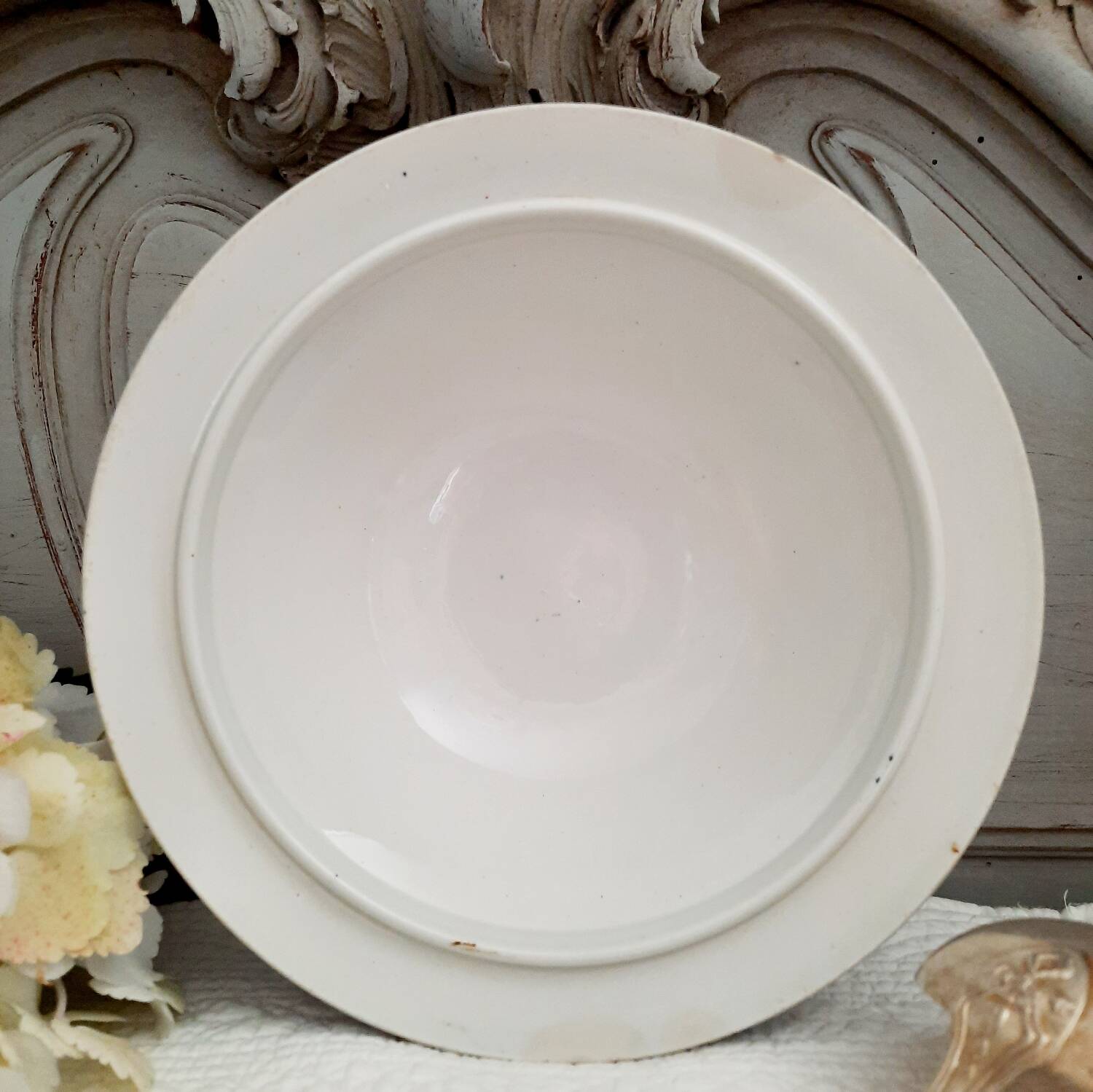 Old mismatched hollow plates in iron earth earthenware accompanied by a soup tureen