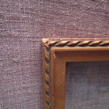 Old wooden and gilded stucco frame