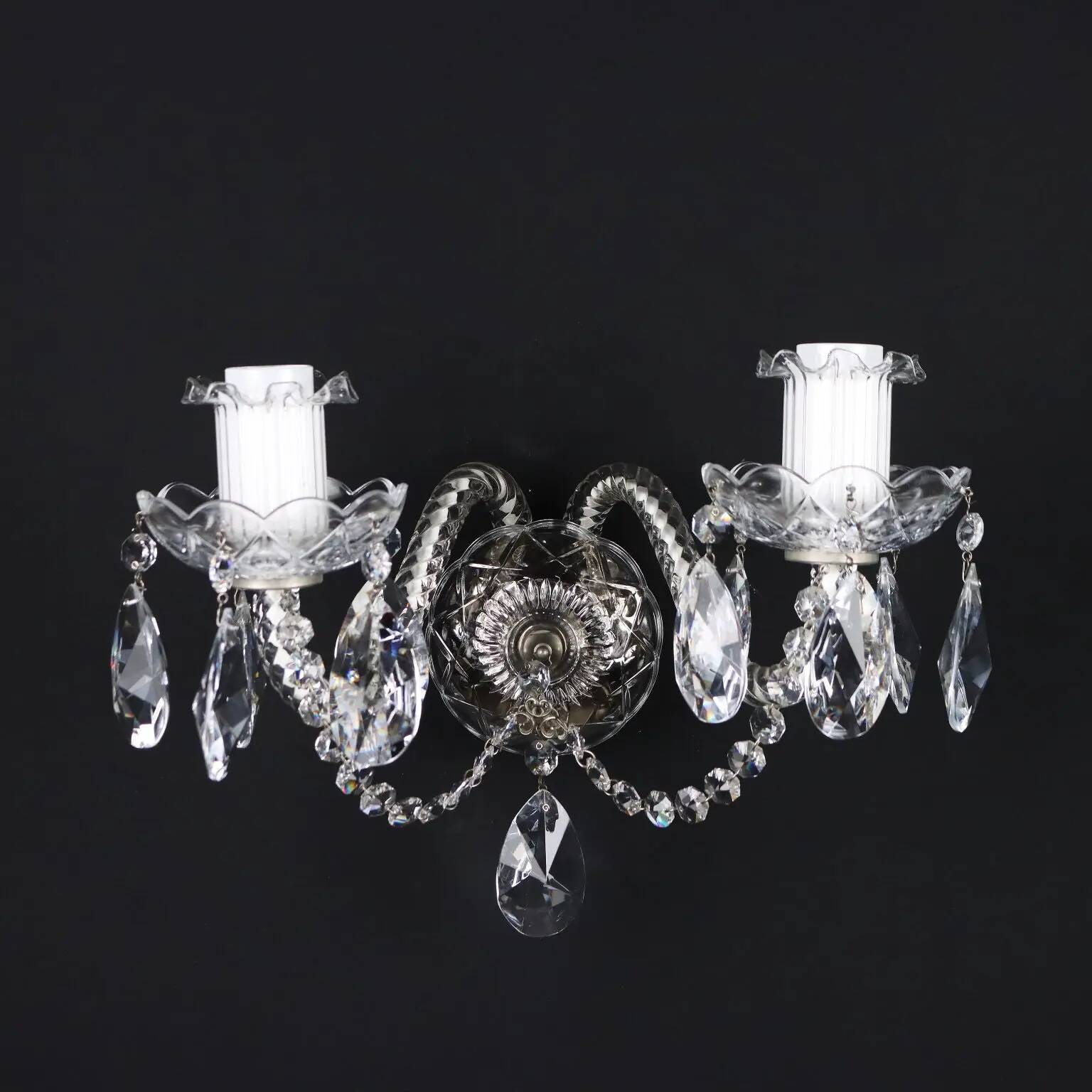 Antique wall light with 2 lights from the 1900s, featuring crystal bobeches and pendants.