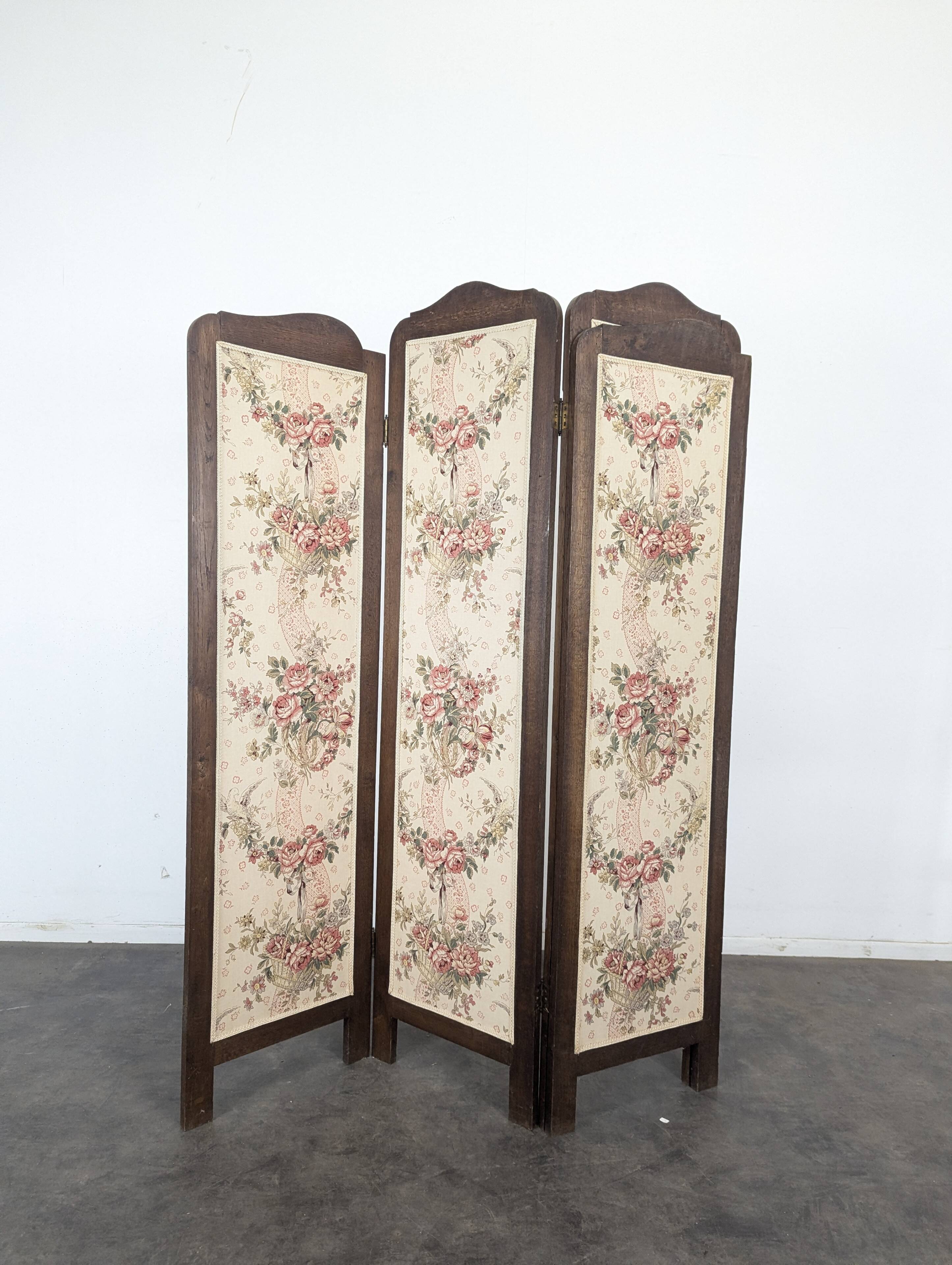 Four-panel oak screen adorned with floral upholstery from the 1930s.