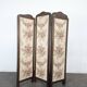 Four-panel oak screen adorned with floral upholstery from the 1930s.