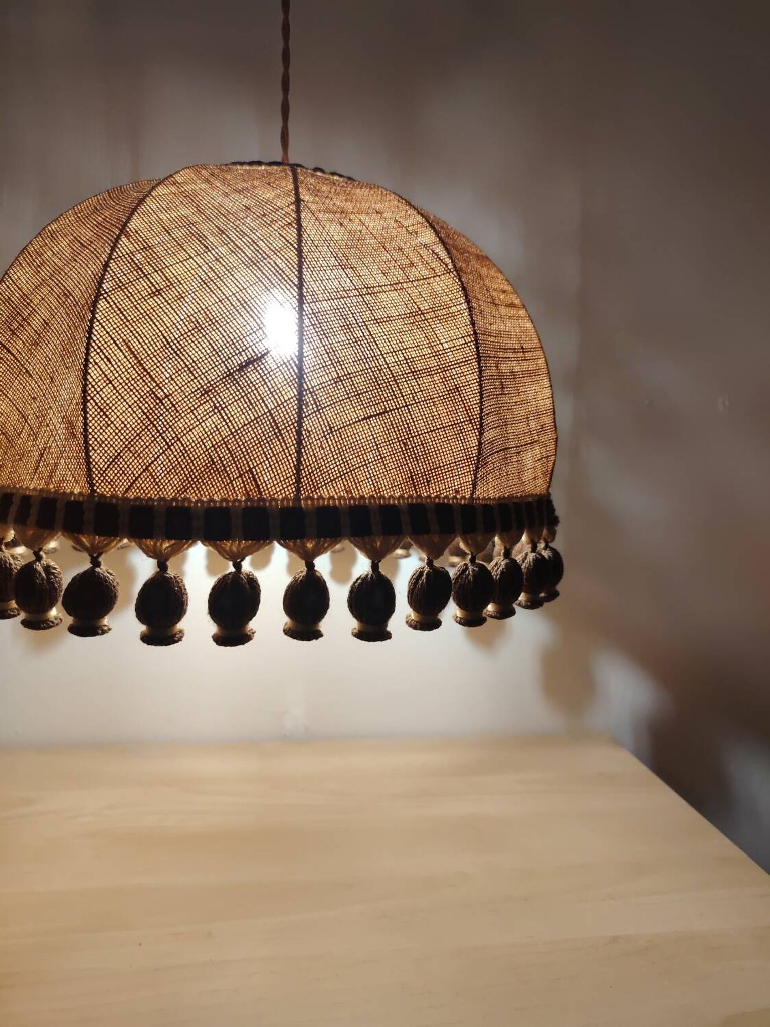 Large hanging pendant light with a burlap and pom-pom style
