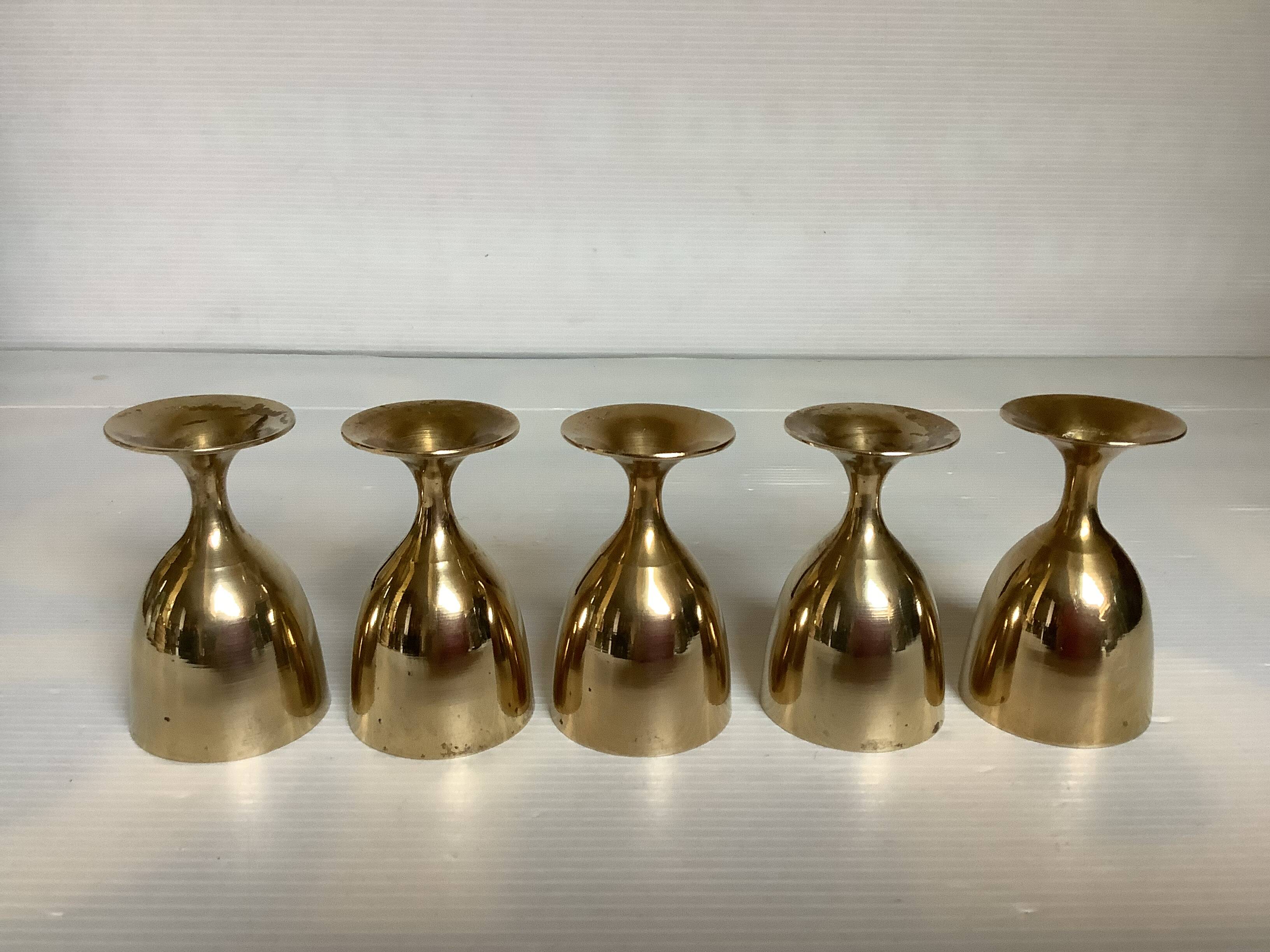 Five brass egg cups