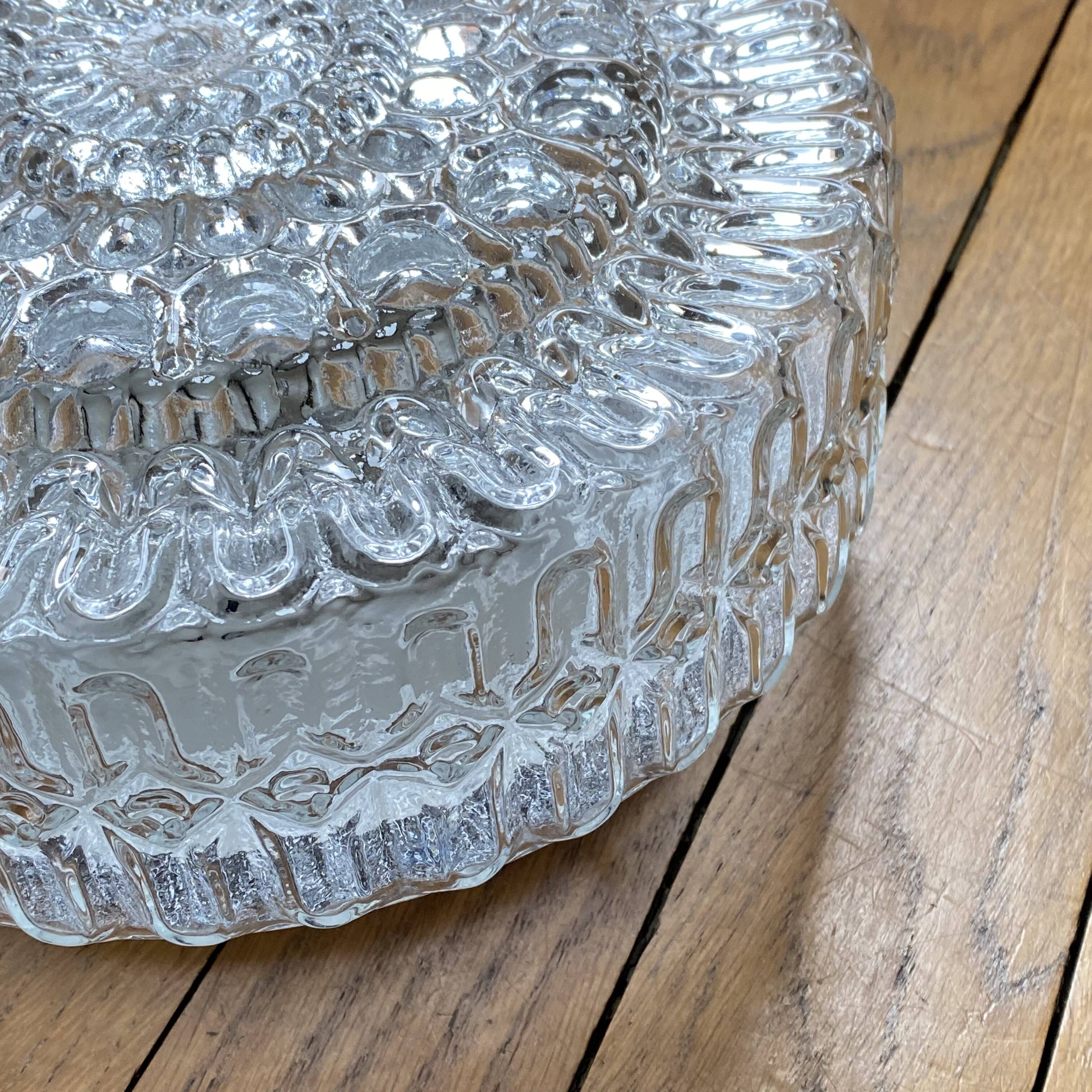 Large wall-mounted ceiling light with transparent glass.