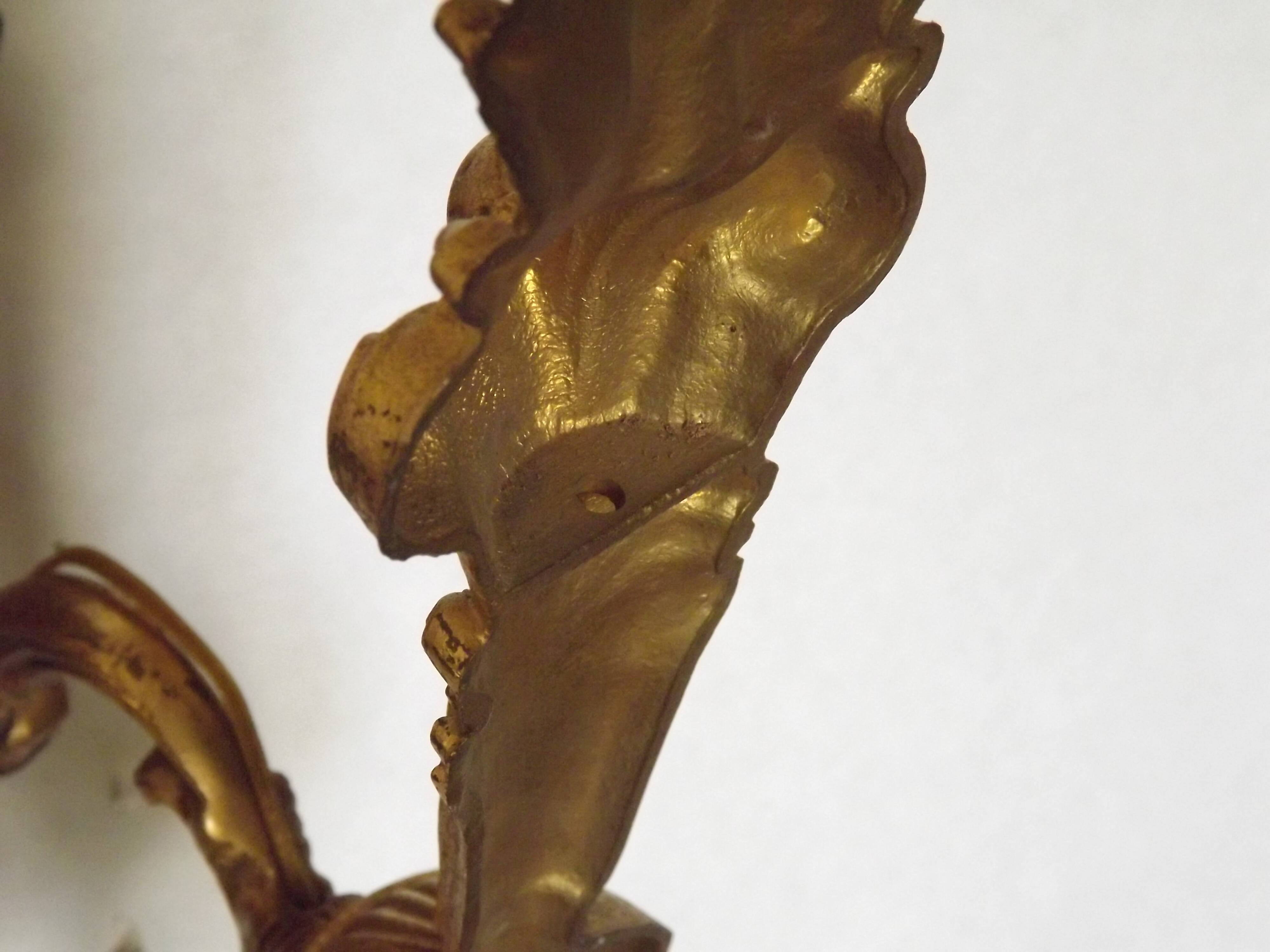 Pair of simple vintage French wall sconces in Art Nouveau bronze with leaf-shaped details.