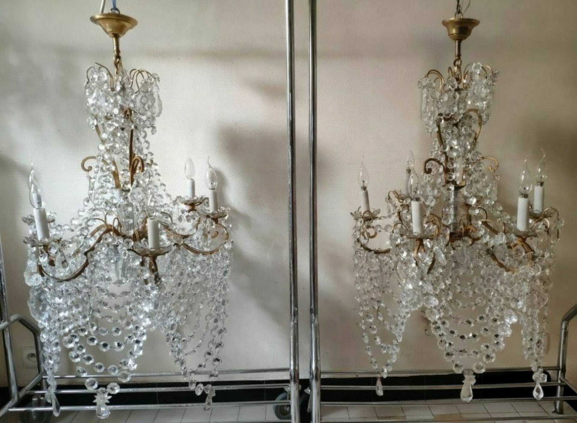 A pair of imposing, antique chandeliers with pendants.