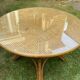 Canned rattan dining table and vintage glass