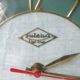Pendulum wall clock Lutetia in green formica of the 1950s
