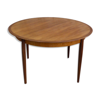 Vintage round teak dining table with hidden extension by publisher MANN, Scandinavian style