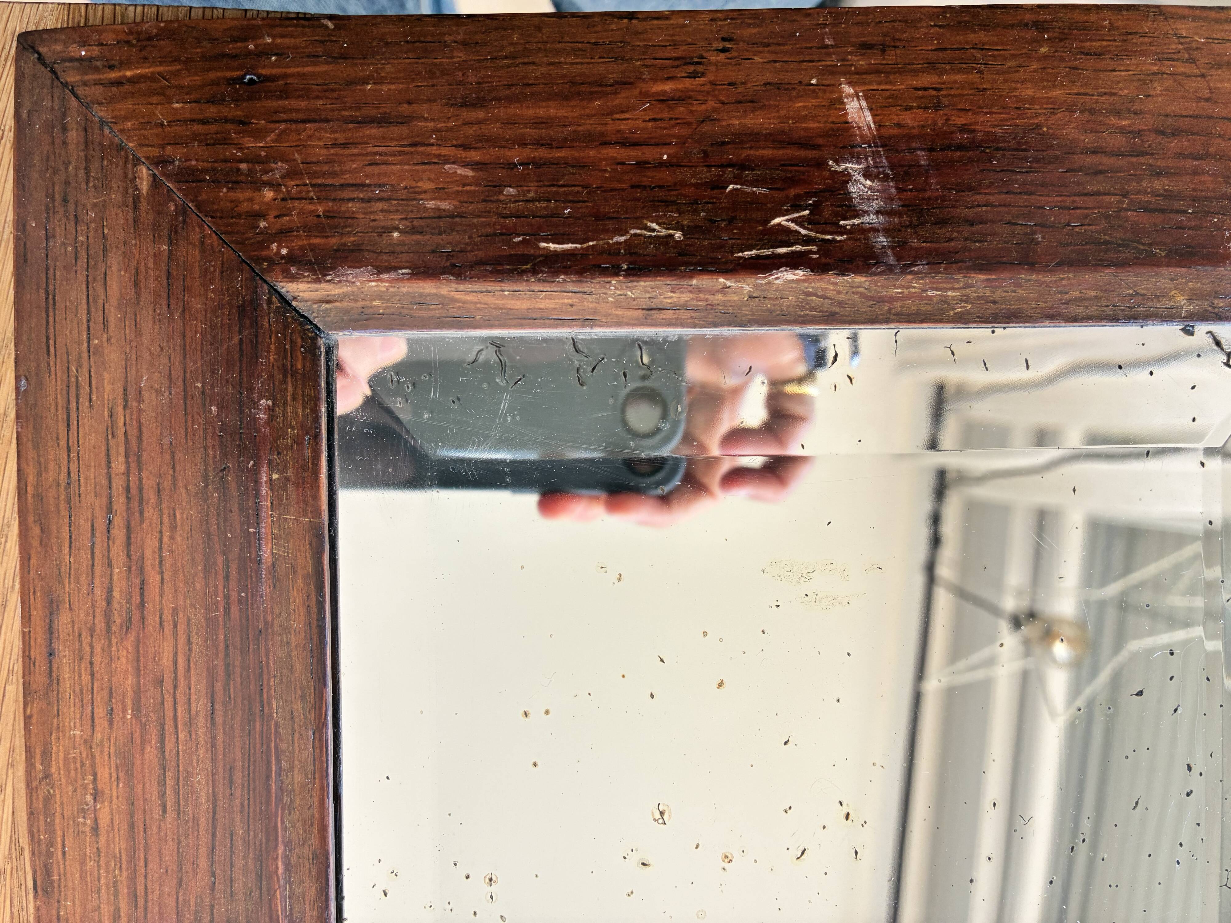 Bevelled mercury mirror with a wooden frame