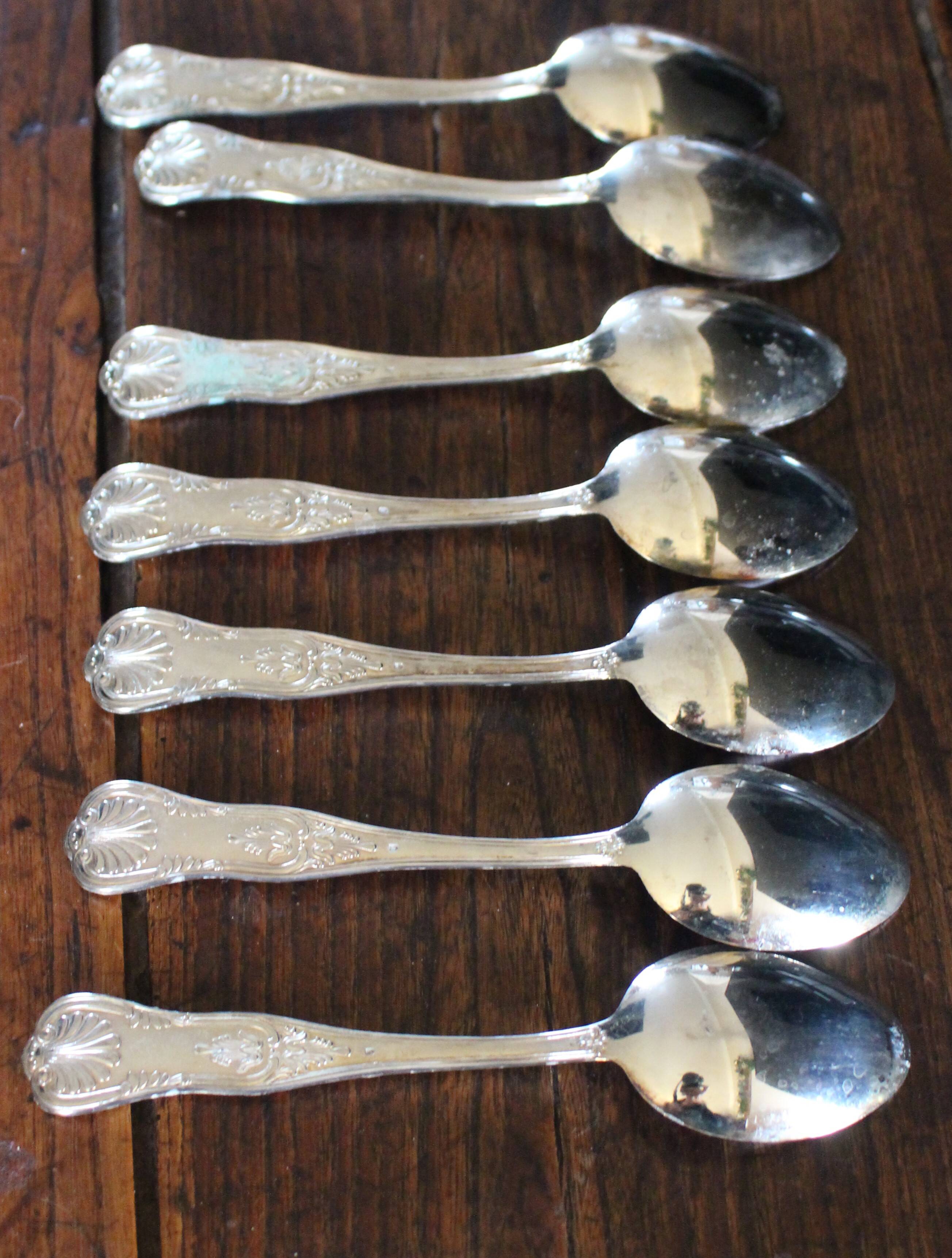 A set of 7 large metal shell spoons