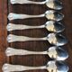 A set of 7 large metal shell spoons