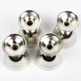 Four silver-plated Christofle egg cups with fluted sides.