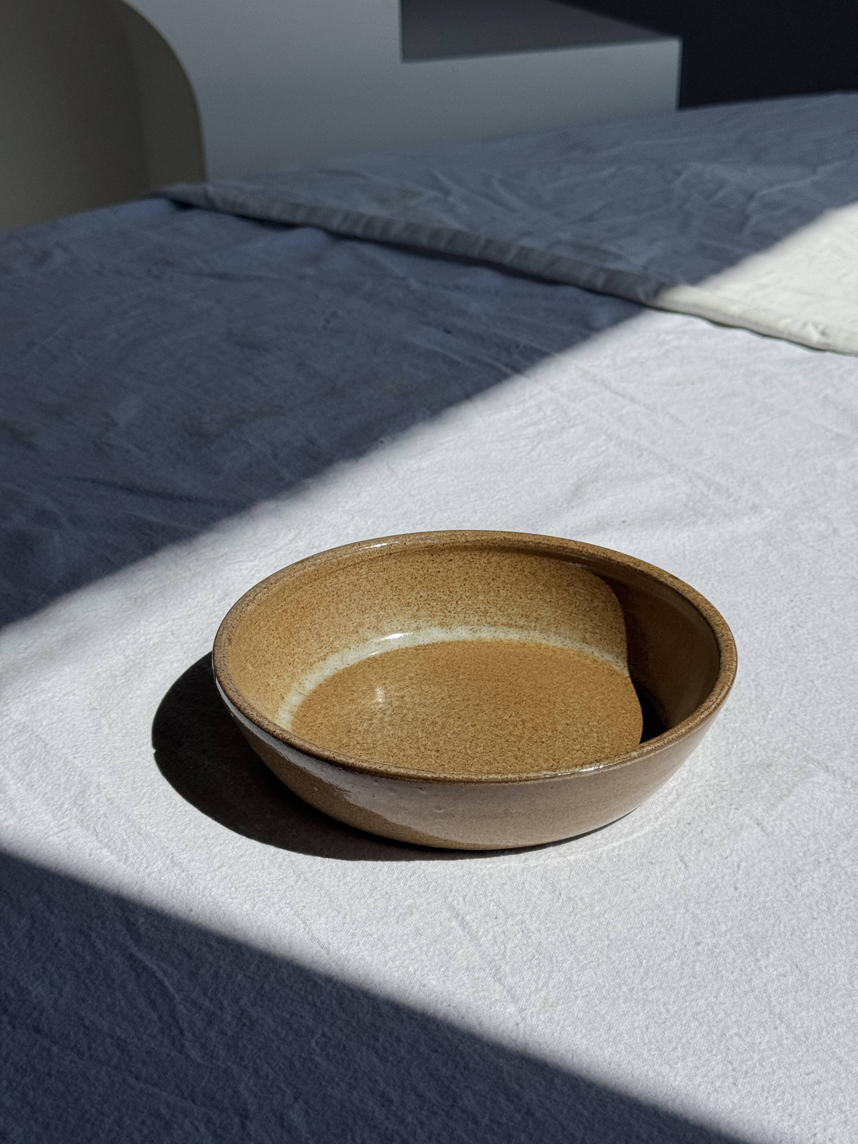 A solid brown flat-bottomed stoneware bowl D18