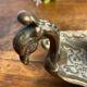 Hand candlestick, peacock shape, in bronze
