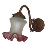 French Art Nouveau wall sconce in bronze with a white and pink glass shade.