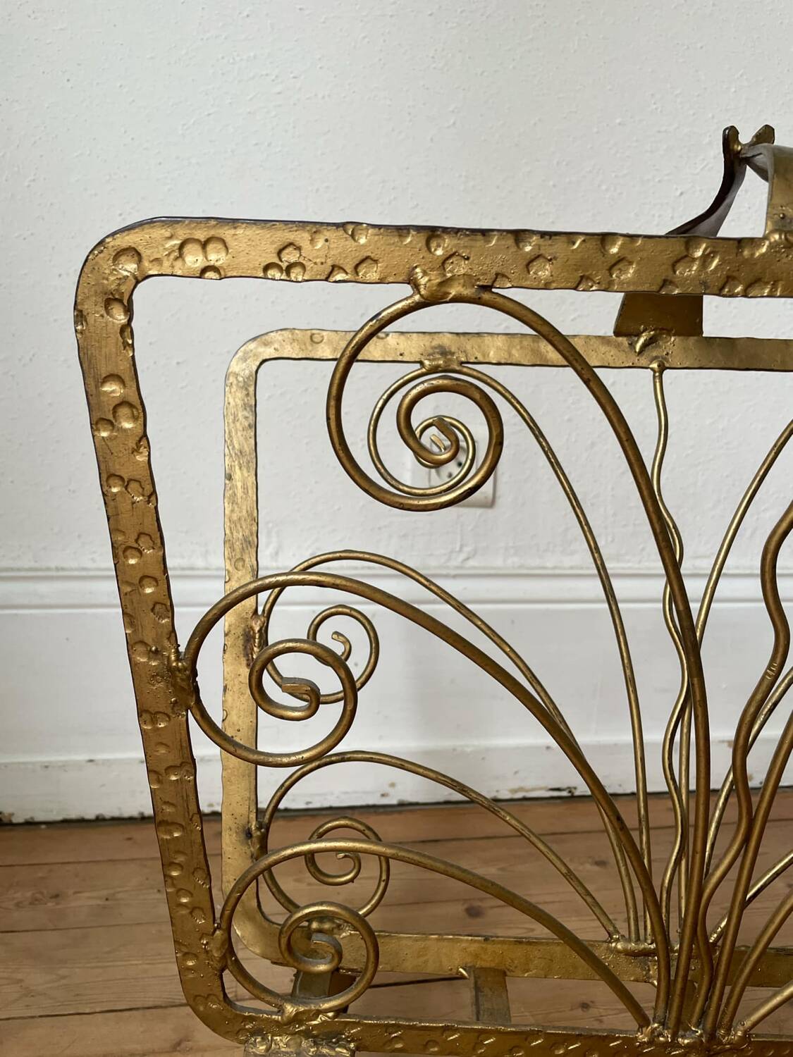 Vintage wrought iron magazine rack with gold butterfly design