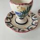 Pair of HB Quimper egg cups with integrated pedestal base, floral decoration