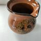 Glazed earthenware pitcher signed HR with a design of stylised birds.
