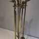 Neoclassical brass fire accessory with duck head decorations.