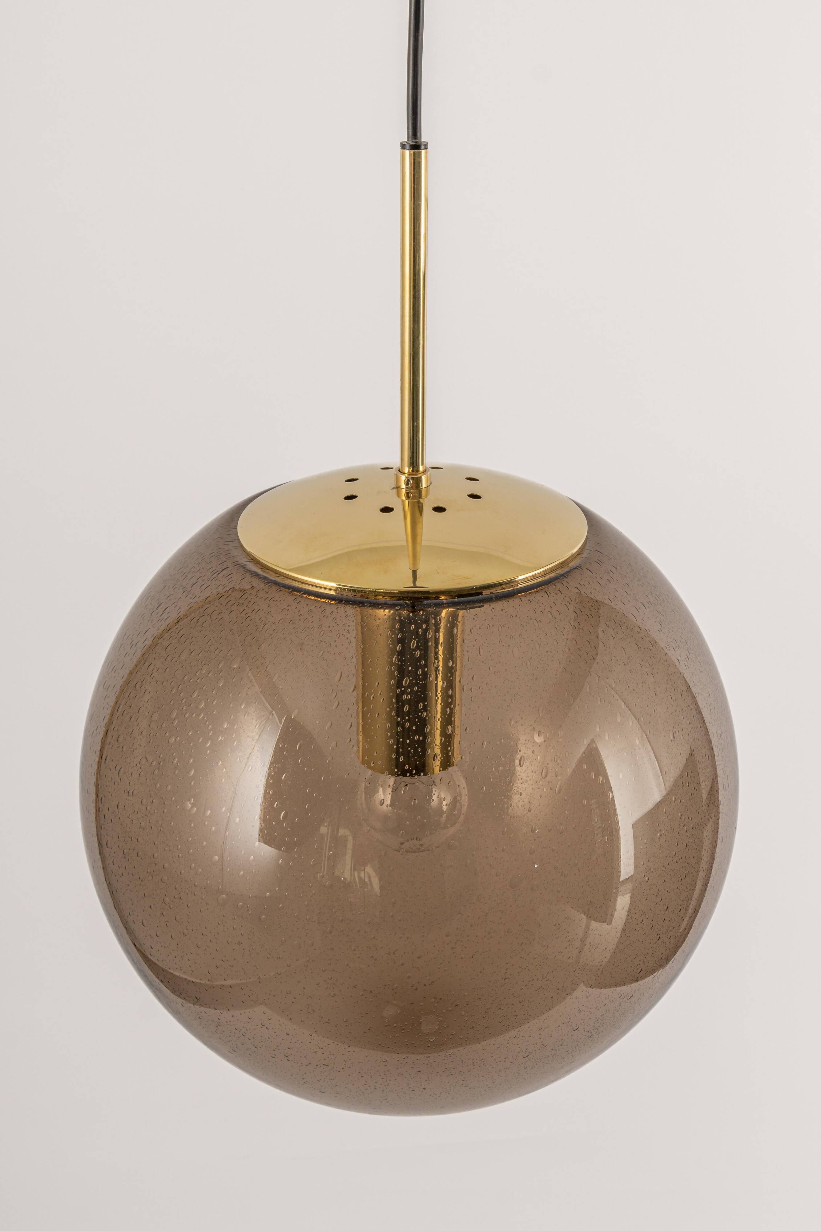 Large smoked glass ball pendant by Limburg in brass, Germany, 1970s.