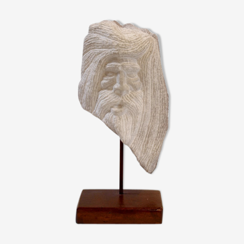 Carved stone head sculpture