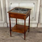 Refreshment table in mahogany, grey marble top, two zinc buckets, 18th century.