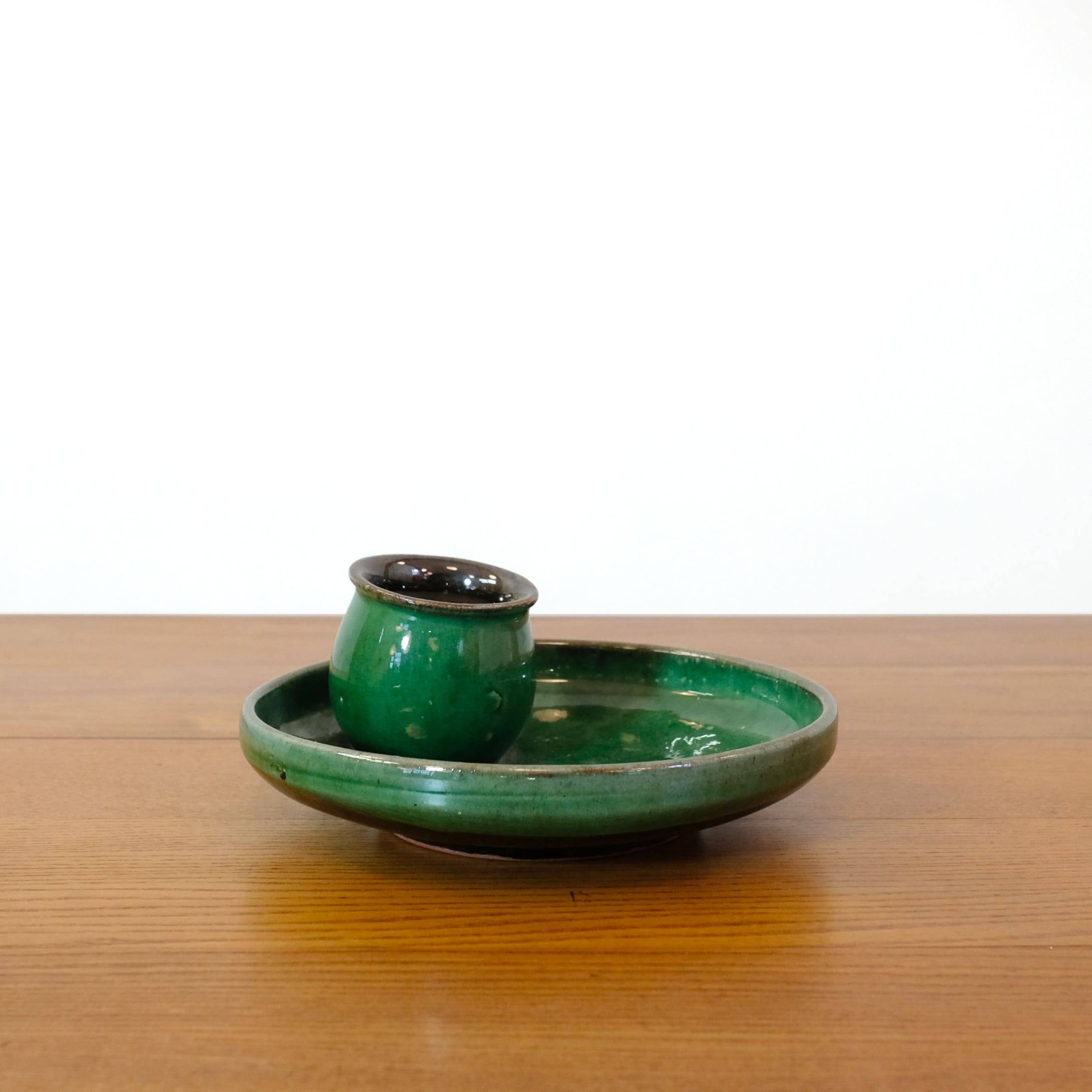 Glazed green earthenware candlestick