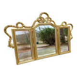 Triptych-shaped mirror in gilded wood and carved with a frieze