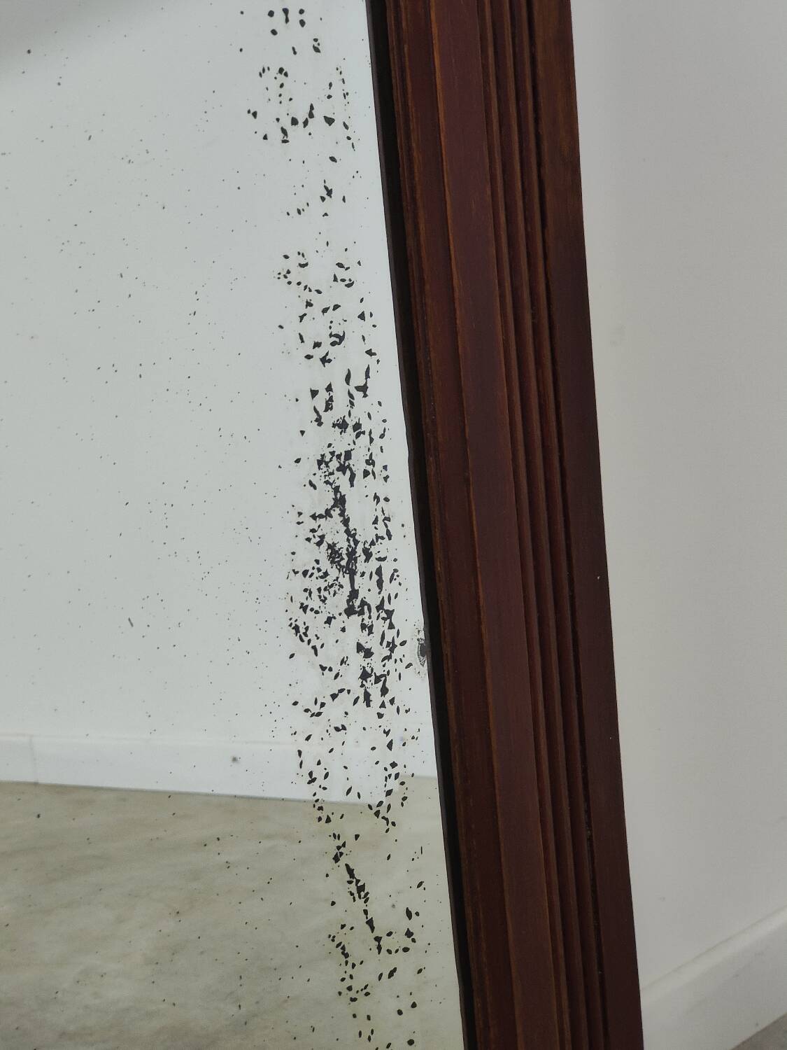 Antique beveled mirror on a wooden frame, 1930