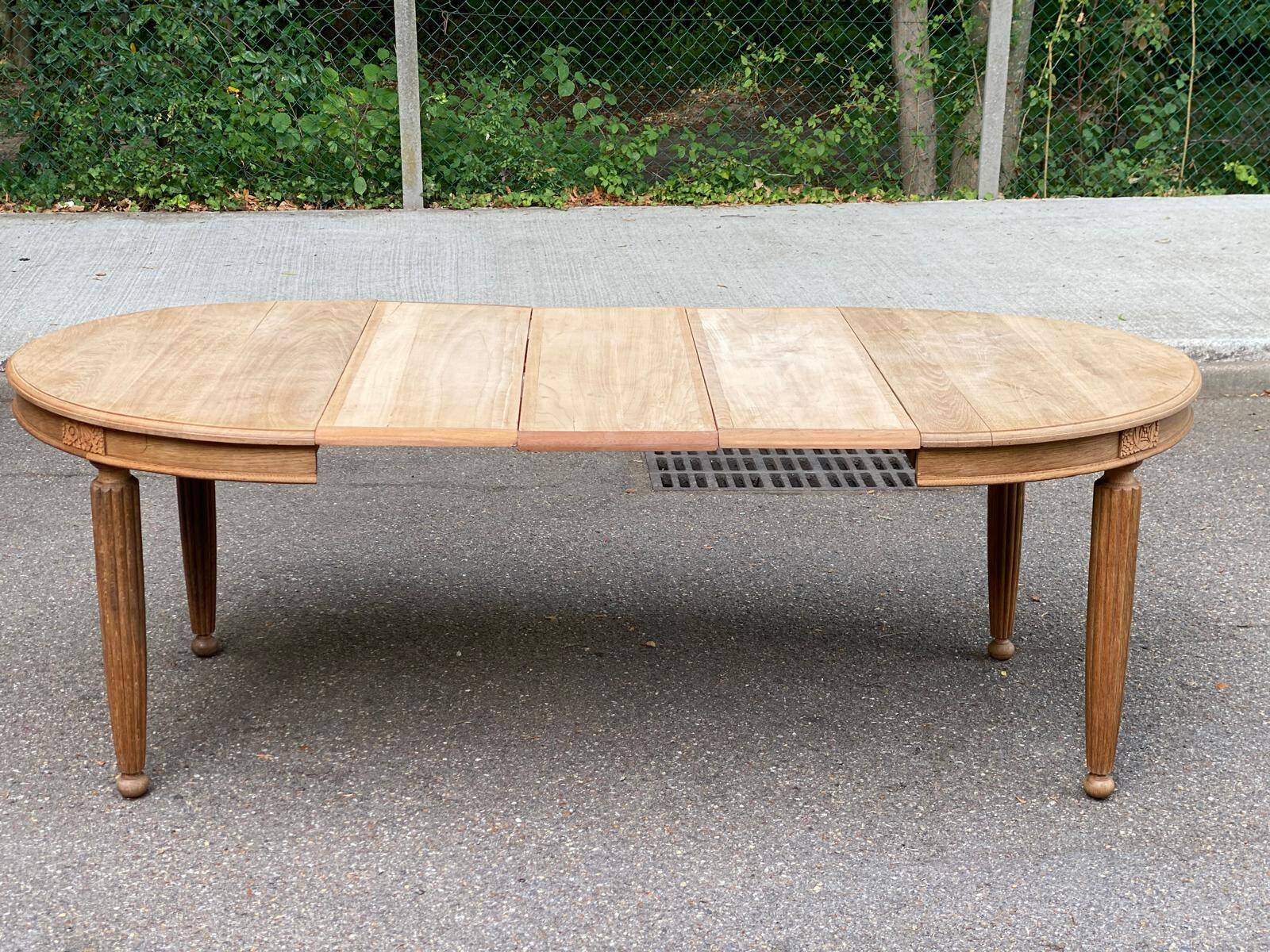 Large stripped solid oak dining table in Louis XVI style with 3 extensions.