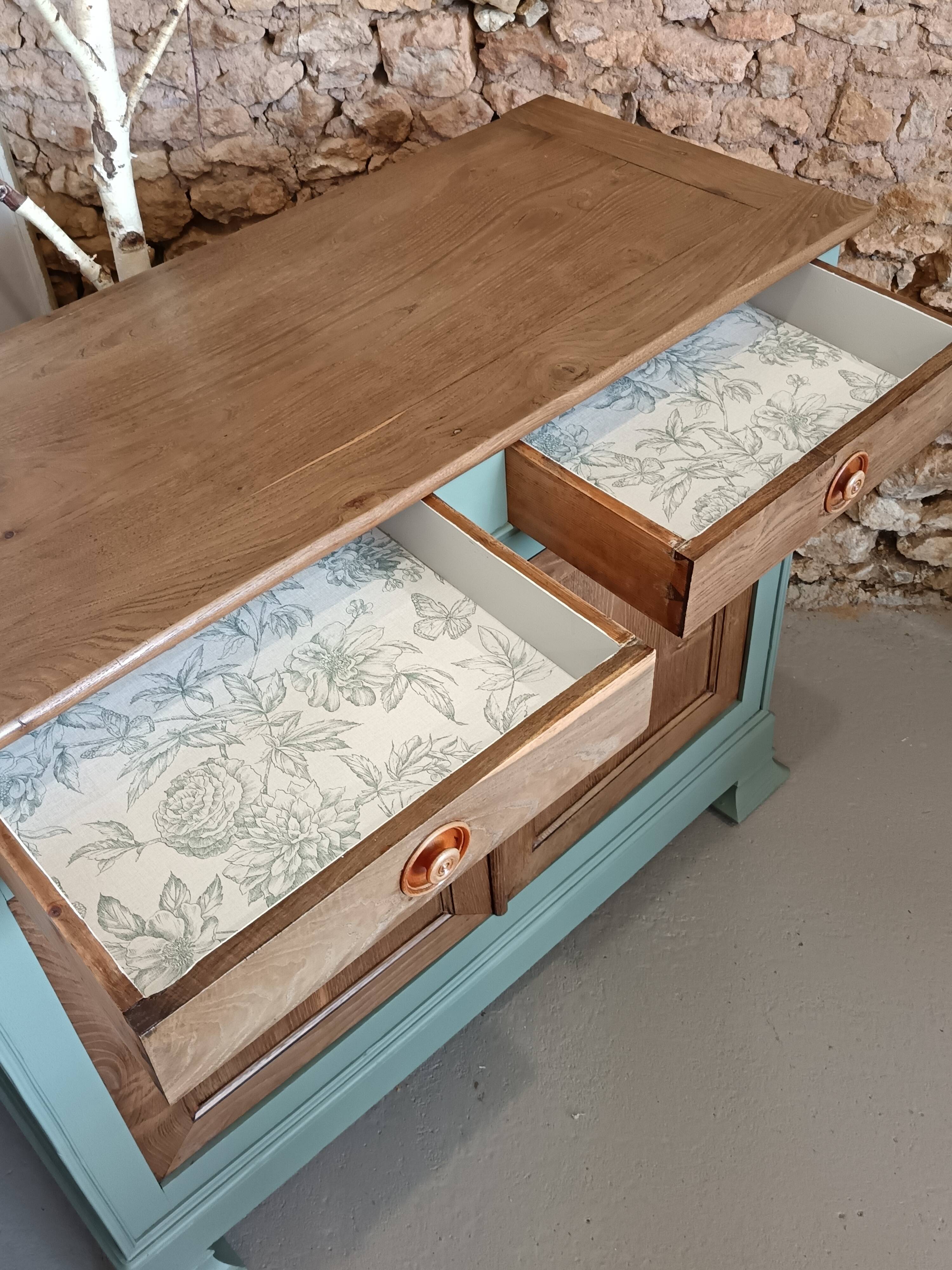 Buffet made of natural wood and bronze green.