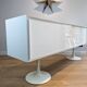 A vintage mid century space age sideboard with white sliding doors
