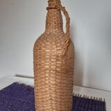 Old high wicker glass bottle