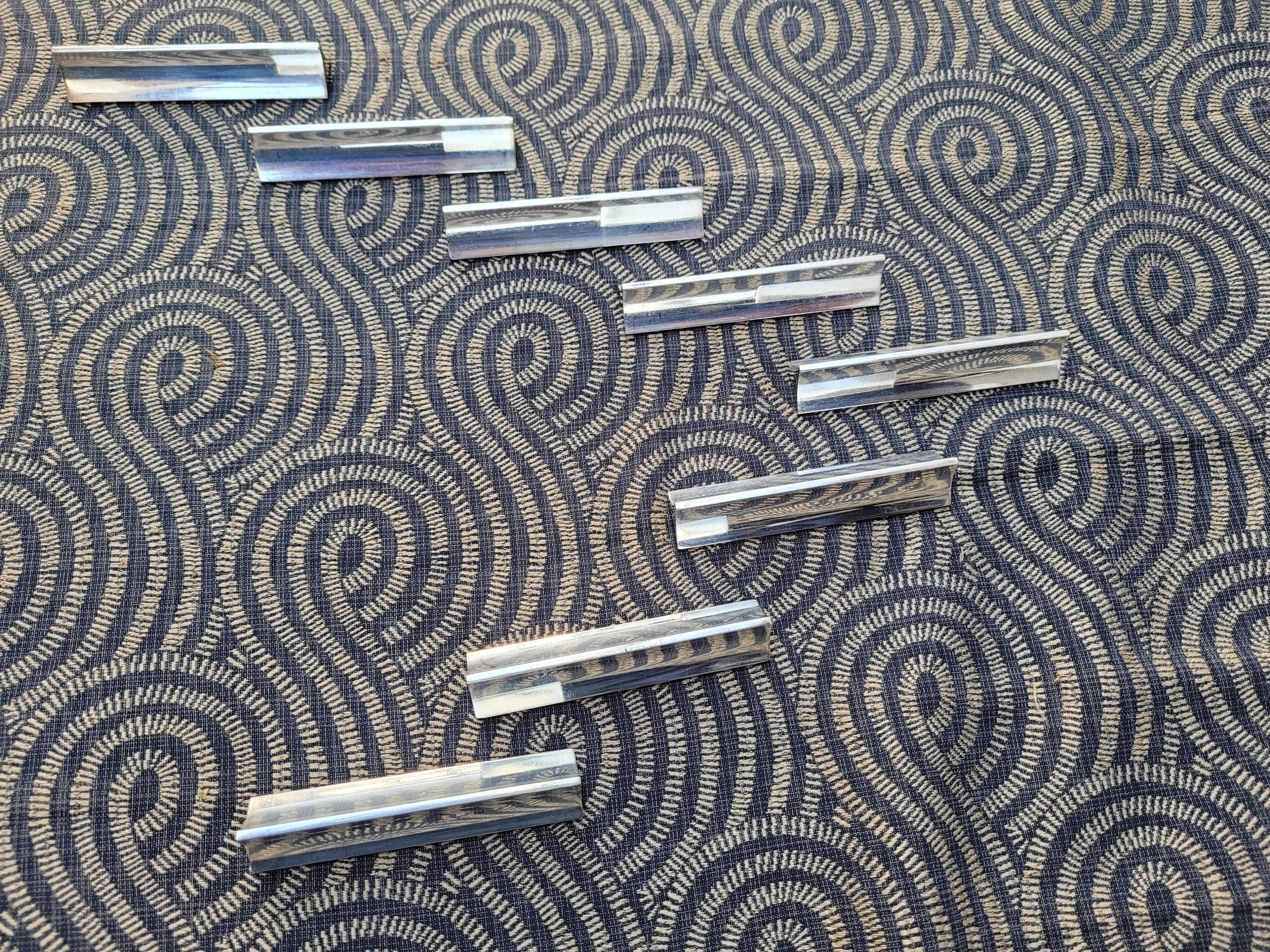 Eight Boulenger knife holders in art deco silver metal