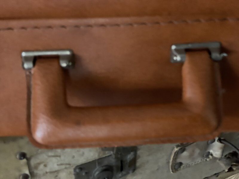 Antique suitcase with brown leather straps